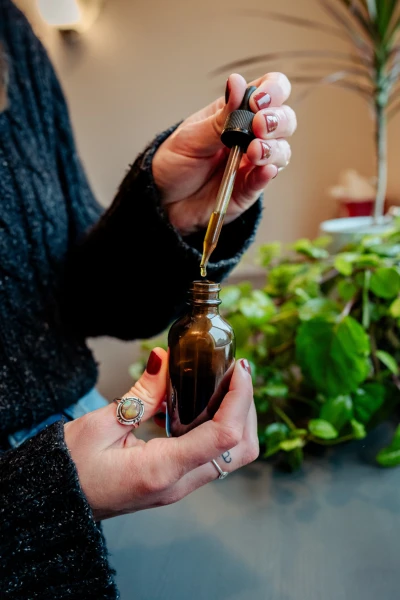 Midwife Caroline Sausler holds an herbal tincture to help with pregnancy related issues